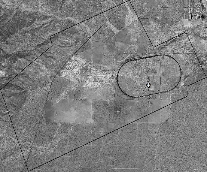 WorldView-1 50cm resolution orthophoto, created from the WorldView-1 stereo photos, for the area of the LiDAR survey used in this study. The 7.5 mile oval track is the Honda California Test Track. The single ground reference point is shown as a white cross.
